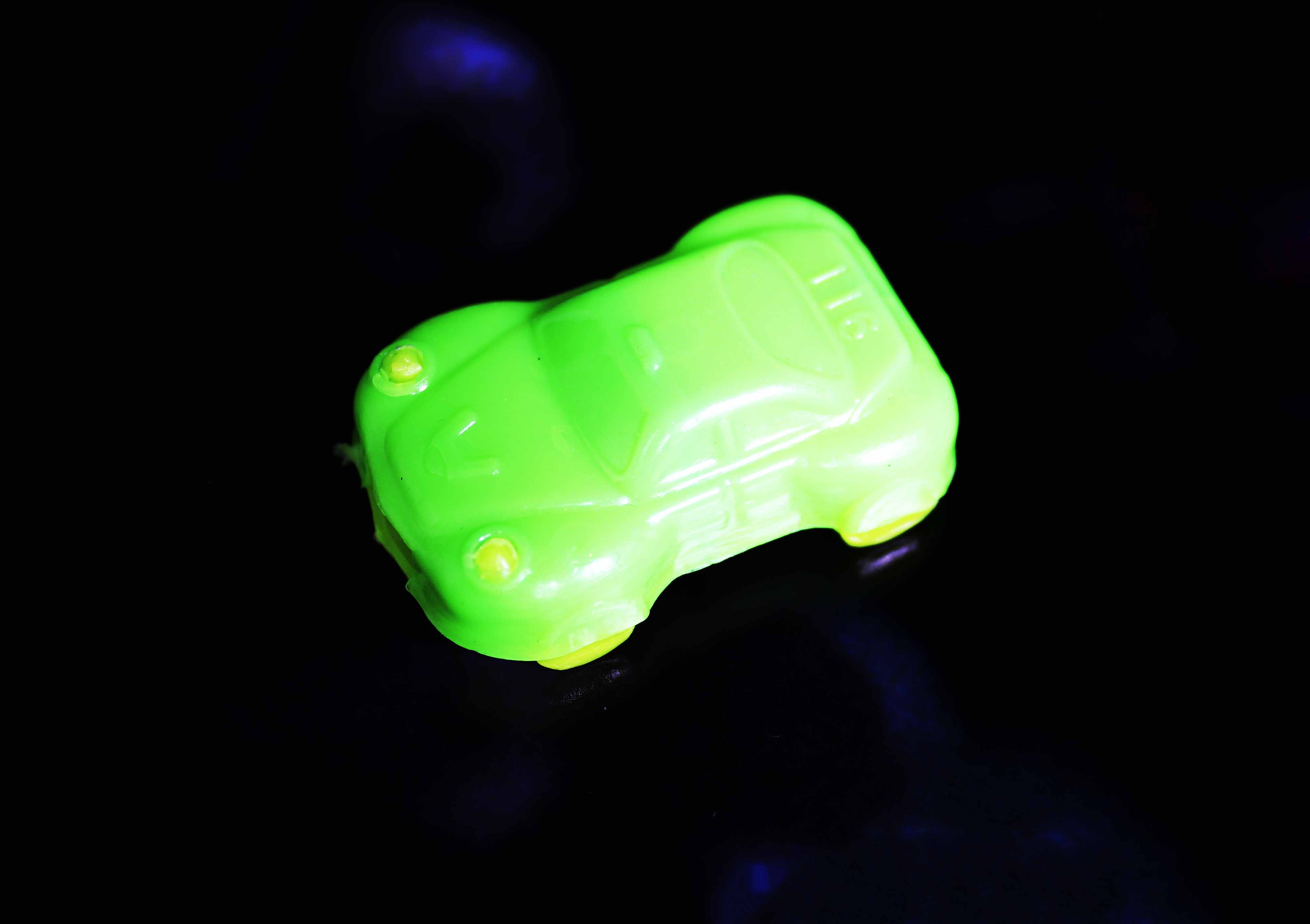 Image captures a miniature green toy car, won from an arcade