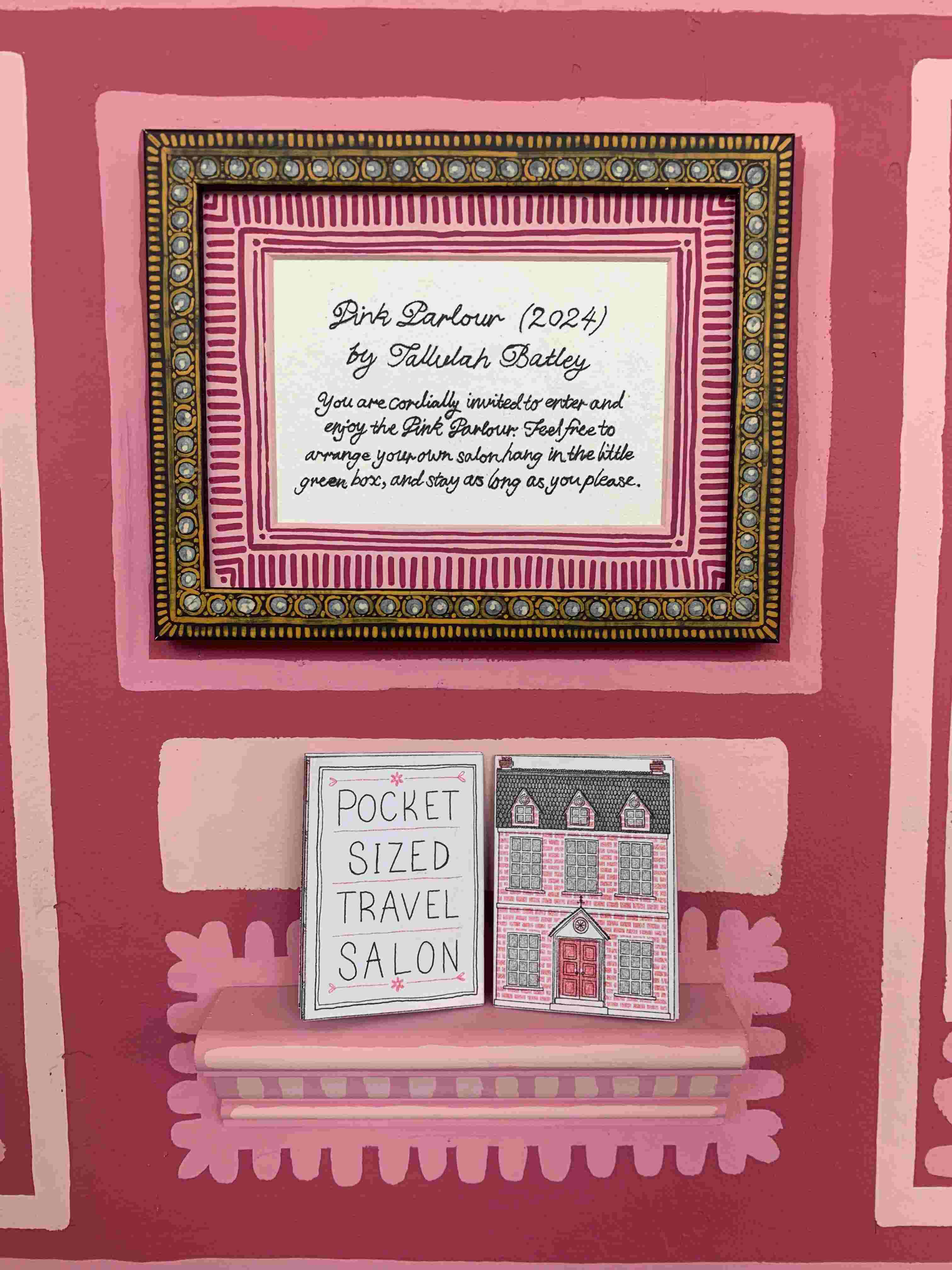 frame on pink wall with a shelf underneath