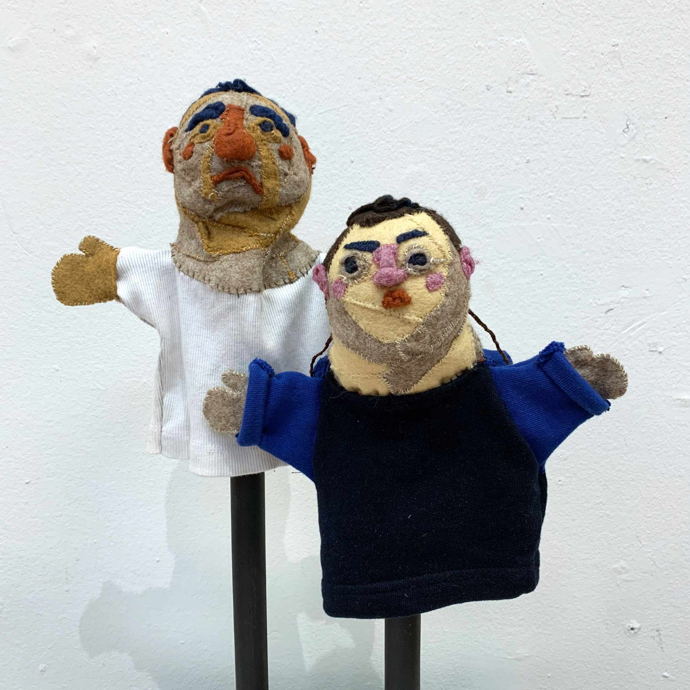 two felt and scrap fabric puppets on stands